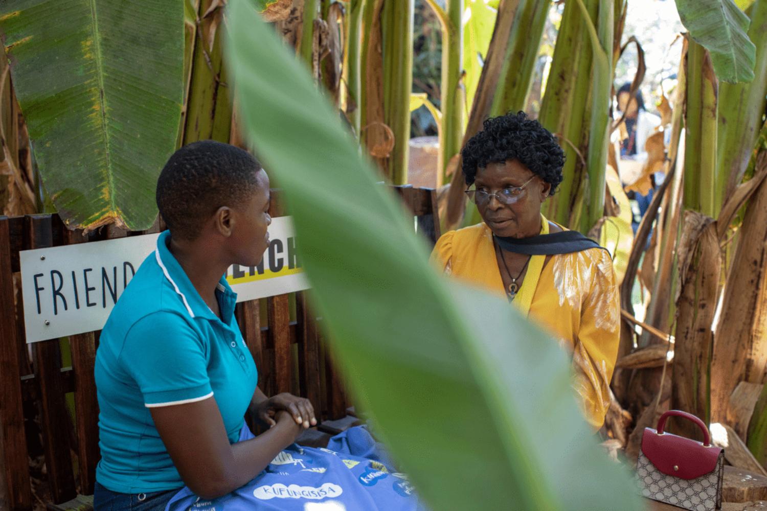 Kusikwenyu on the bench with client Vimbai Madziwa in Zimbabwe