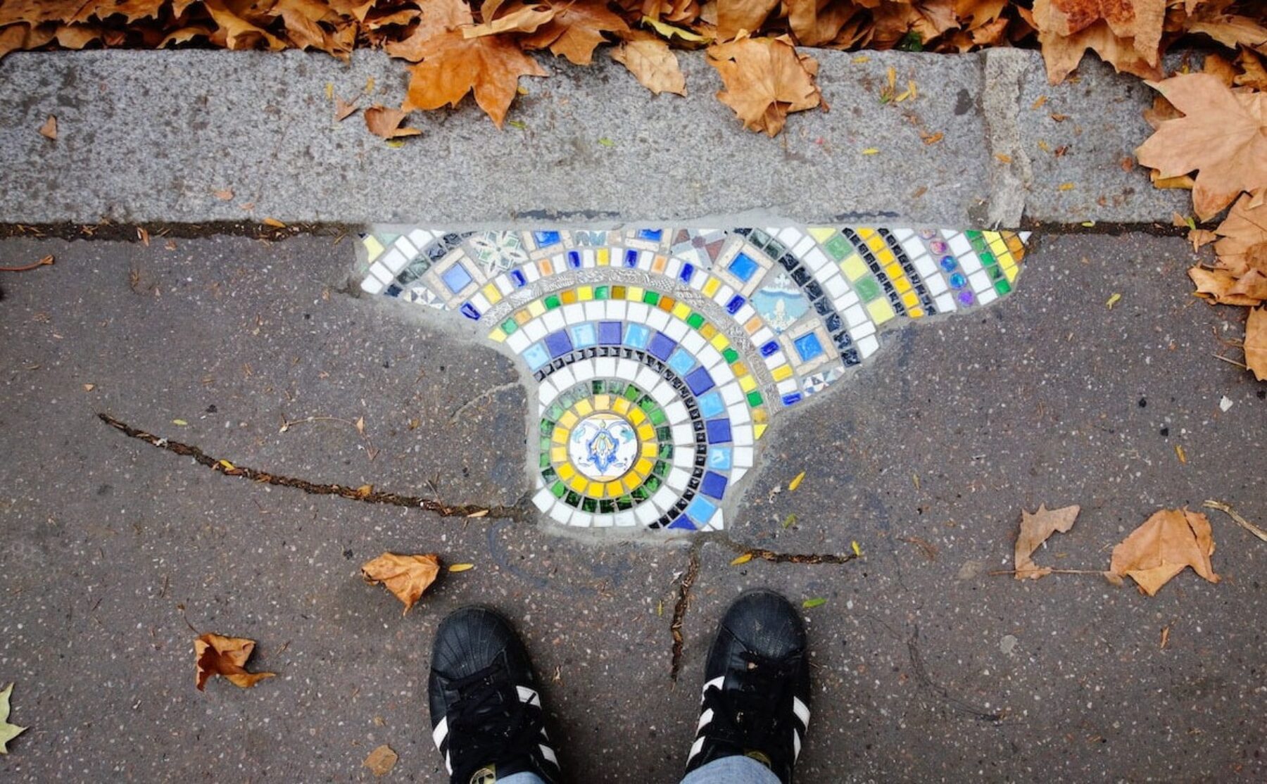 Image for The guerrilla artist filling Europe’s potholes with colourful mosaics