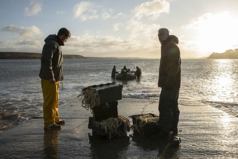 A team from Swansea University prepares to plant seagrass seeds in Dale Bay