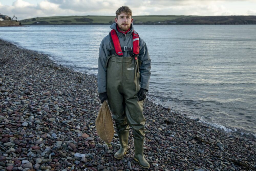 A volunteer prepares to sow seeds to restore sea meadows